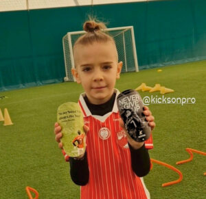 Young football player wearing Kickson shin pads at training